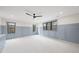 Spacious bedroom featuring light blue wainscoting, neutral walls and carpet, and black trimmed windows at 5213 Bent Leaf Dr, Raleigh, NC 27606