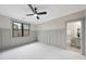 Comfortable bedroom with neutral colors, featuring a ceiling fan and an attached bathroom at 5213 Bent Leaf Dr, Raleigh, NC 27606