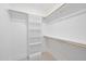 Bright walk-in closet, featuring built-in shelving and wooden rods for optimal storage solutions at 5213 Bent Leaf Dr, Raleigh, NC 27606