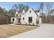 Beautiful home showcasing its white brick facade, black trim, and attached garage at 5213 Bent Leaf Dr, Raleigh, NC 27606