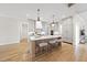 Bright, open kitchen with a large island, modern appliances, and beautiful hardwood floors at 5213 Bent Leaf Dr, Raleigh, NC 27606