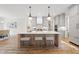 Bright kitchen with large island, pendant lights and light gray cabinetry at 5213 Bent Leaf Dr, Raleigh, NC 27606