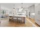 Bright open kitchen with a large island, pendant lights, and dining area at 5213 Bent Leaf Dr, Raleigh, NC 27606