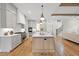 Bright, open kitchen with a large island, modern appliances and stairs to the second level at 5213 Bent Leaf Dr, Raleigh, NC 27606