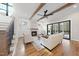 Open living room featuring a fireplace, exposed beams, hardwood floors, and plenty of natural light at 5213 Bent Leaf Dr, Raleigh, NC 27606