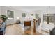 Bright living room with hardwood floors, neutral furnishings, and three windows offering views of nature at 5213 Bent Leaf Dr, Raleigh, NC 27606