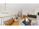 Open concept living room with hardwood floors, comfortable seating, and a view of the stairs at 5213 Bent Leaf Dr, Raleigh, NC 27606