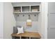 Mudroom with coat hooks, a bench with storage, and decorative pillows and baskets at 5213 Bent Leaf Dr, Raleigh, NC 27606