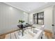 Cozy office features wainscoting, a modern desk, plush chairs, and natural light at 5213 Bent Leaf Dr, Raleigh, NC 27606