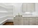 Bright pantry with shelving, sink and light gray cabinetry at 5213 Bent Leaf Dr, Raleigh, NC 27606