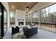 Inviting screened porch features a wood ceiling, brick fireplace, and comfortable seating area at 5213 Bent Leaf Dr, Raleigh, NC 27606