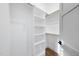 Well-organized walk-in closet with ample shelving and wooden rods for optimal storage at 5213 Bent Leaf Dr, Raleigh, NC 27606