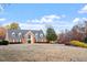 Beautiful brick home with a well-manicured front lawn and classic architectural details at 5321 Cog Hill Ct, Raleigh, NC 27604