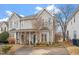 Beautiful exterior elevation of a charming two-story townhome featuring a welcoming front porch at 5321 Cog Hill Ct, Raleigh, NC 27604