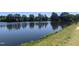 Calm lake view lined with mature trees, reflecting the sky and adding to the community's natural beauty at 5321 Cog Hill Ct, Raleigh, NC 27604