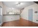 Open-concept living area with hardwood floors, bright lighting, and neutral wall color at 5321 Cog Hill Ct, Raleigh, NC 27604