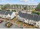 Aerial view of townhomes with neat landscaping, parking area, and residential surroundings at 533 Berry Chase Way, Cary, NC 27519