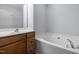 Bright bathroom features vanity with wood cabinets, soaking tub, and neutral paint at 533 Berry Chase Way, Cary, NC 27519