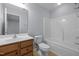 Bathroom with wood cabinet vanity, single sink, toilet, and shower-tub combo at 533 Berry Chase Way, Cary, NC 27519