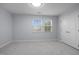 Bright bedroom with neutral walls, carpet, double window, and white closet doors at 533 Berry Chase Way, Cary, NC 27519