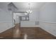 Elegant dining area with hardwood floors, classic wainscoting, and a chandelier, open to living spaces at 533 Berry Chase Way, Cary, NC 27519