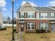 Exterior of a townhome with brick facade, decorative shutters, and small front yard at 533 Berry Chase Way, Cary, NC 27519