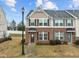 Inviting townhouse with brick and siding, a front lawn, and detailed trim, perfect for comfortable living at 533 Berry Chase Way, Cary, NC 27519