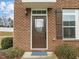 Inviting front door with brick surround, stylish light fixture, and manicured landscaping at 533 Berry Chase Way, Cary, NC 27519