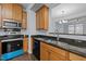 Modern kitchen featuring a stainless steel sink, oven, and granite countertops that enhance functionality and style at 533 Berry Chase Way, Cary, NC 27519