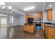 Bright kitchen with stainless steel appliances, island, and sliding glass doors leading to the backyard at 533 Berry Chase Way, Cary, NC 27519