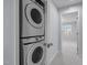 Hallway laundry room features stacked washer and dryer at 533 Berry Chase Way, Cary, NC 27519