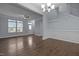 Inviting living and dining area featuring hardwood floors, natural light, and convenient access to a half bathroom at 533 Berry Chase Way, Cary, NC 27519