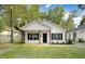 Charming single-story home with white siding, black shutters, and a well-maintained front yard at 5512 Hickory Ln, Raleigh, NC 27603