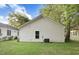 Rear exterior view of a well-maintained home with white siding and a green lawn at 5512 Hickory Ln, Raleigh, NC 27603