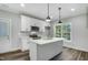 Stylish kitchen featuring white cabinets, stainless steel appliances, and ample counter space at 5512 Hickory Ln, Raleigh, NC 27603