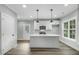 Modern kitchen with an island, white cabinets, and pendant lighting at 5512 Hickory Ln, Raleigh, NC 27603