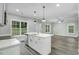 Bright kitchen with island, stainless steel dishwasher, and a view to the backyard at 5512 Hickory Ln, Raleigh, NC 27603