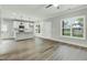 Open-concept living room flowing into the kitchen with new appliances and hardwood flooring at 5512 Hickory Ln, Raleigh, NC 27603