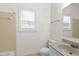 Light bathroom with tile flooring, vanity, toilet, and window, with a shower over the tub at 5738 Sentinel Dr, Raleigh, NC 27609