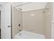 Clean and well-maintained tiled shower over tub and a new showerhead with a tiled wall at 5738 Sentinel Dr, Raleigh, NC 27609