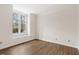 Spacious bedroom with hardwood floors and a bright window with natural light, perfect for relaxation at 5738 Sentinel Dr, Raleigh, NC 27609