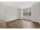 Primary bedroom with hardwood floors and a large window at 5738 Sentinel Dr, Raleigh, NC 27609