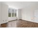 Neutral bedroom has hardwood floors and a large window at 5738 Sentinel Dr, Raleigh, NC 27609