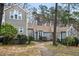 Charming home exterior with lush greenery and a stone walkway, perfect for outdoor enjoyment at 5738 Sentinel Dr, Raleigh, NC 27609