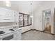 Bright kitchen features white appliances, countertops, and a window overlooking the backyard at 5738 Sentinel Dr, Raleigh, NC 27609