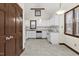 Bright eat-in kitchen featuring white cabinets and tile floors at 5738 Sentinel Dr, Raleigh, NC 27609
