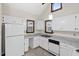 Open kitchen with white cabinets and countertops, and natural light at 5738 Sentinel Dr, Raleigh, NC 27609