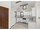 Eat-in kitchen features white appliances, tile floor and bright natural light at 5738 Sentinel Dr, Raleigh, NC 27609