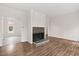 Living room with a tile fireplace, wood floors, and natural light at 5738 Sentinel Dr, Raleigh, NC 27609