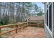 Wide-angle view of a stained-wood deck, showcasing the beautiful view of the wooded surroundings at 5738 Sentinel Dr, Raleigh, NC 27609